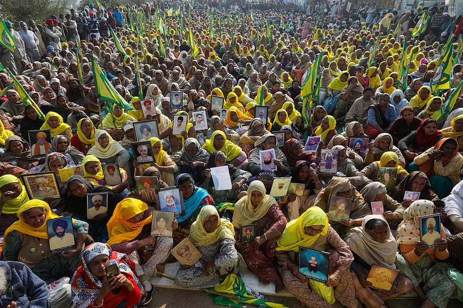 Women, including widows and relatives of farmers who were believed to have killed themselves over debt attend a protest against farm bills. Credit: Reuters