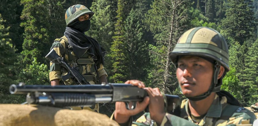 Border Security Force (BSF) personnel stand guard along the Srinagar-Leh National highway, in Ganderbal district of Central Kashmir, Wednesday, June 17, 2020. Credit: PTI Photo
