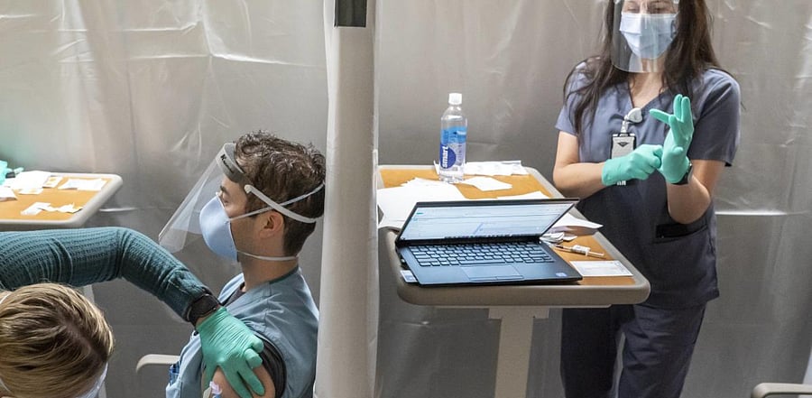 Healthcare workers at the Portland Veterans Affairs Medical Center receive Covid-19 vaccinations. Credit: AFP Photo