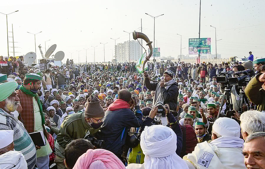 A farmer plays an instrument at 'Khap Panchayat' during a protest against the new farm laws, at Delhi-UP border near Ghazipur in New Delhi, Thursday, Dec. 17, 2020. Credit: PTI Photo