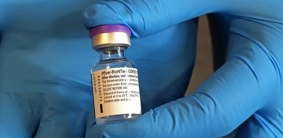 An NHS (National Health Service) worker holds a vial of the Pfizer-Biontech covid-19 vaccine at the Gloucestershire Vaccination Centre at Gloucestershire Royal Hospital. Credit: AFP Photo