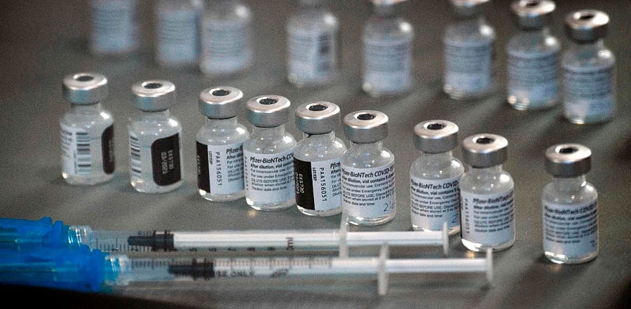 Syringes wand vials of the Pfizer-BioNTech Covid-19 vaccine are prepared to be administered to front-line health care workers. Credit: Reuters Photo