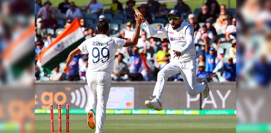 Virat Kohli (R) and Ravi Ashwin celebrate an attempted run-out of Australia's Steve Smith. Credit: AFP