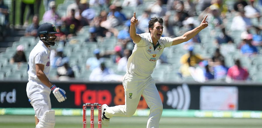 Australian bowler Pat Cummins celebrates after dismissing Indian captain Virat Kohli (L) for 4 runs on day 3 of the first Test match between Australia and India at Adelaide Oval, Adelaide. Credit: Reuters