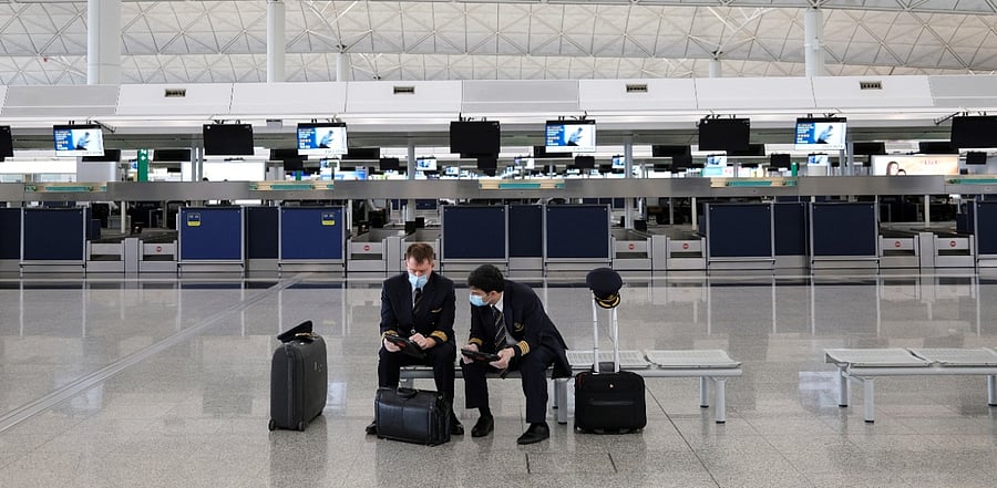 Pilots wearing face masks to avoid the spread of the coronavirus are seen at the Hong Kong International Airport, in Hong Kong. Credit: Reuters Photo
