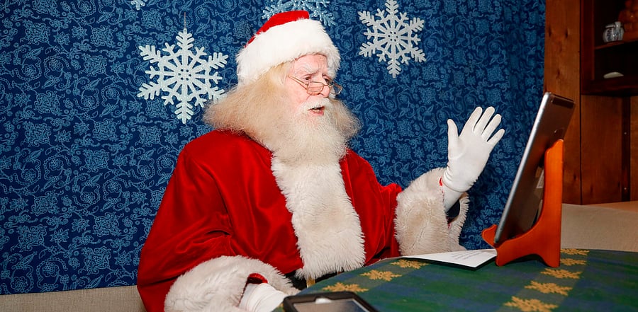 John Sullivan, 81, dressed as Santa Claus records a virtual message for a client at his home in Streamwood, Illinois. Credit: AFP