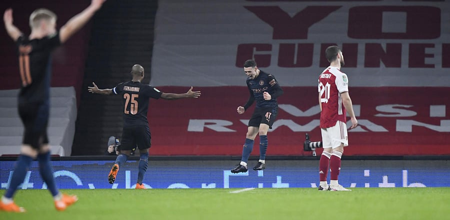 Manchester City's Phil Foden celebrates after scoring his side's third goal during their 4-1 win over Arsenal in the League Cup quarterfinals. Credit: Reuters