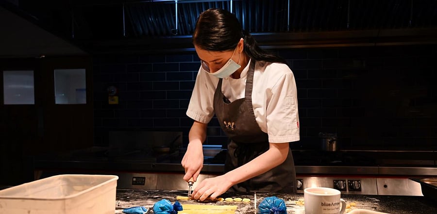 A chef at the Wood Manchester restaurant, prepares pasta that will form part of a high-end meal kit for delivery in Manchester, northwest England. Credit: AFP