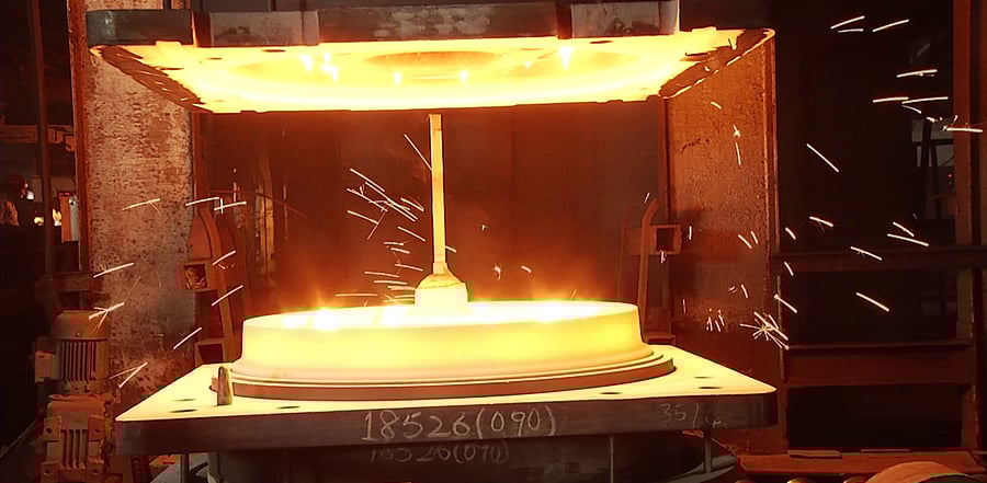 Splitting of a freshly cast wheel at the furnace of Rail Wheel Factory in Yelahanka. Credit: DH Photo