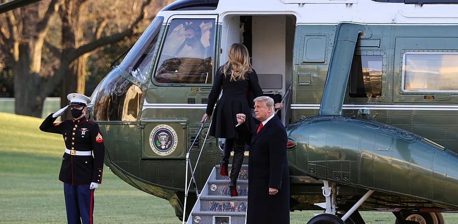 US President Donald Trump, accompanied by first lady Melania Trump, makes a fist as he prepares to board Marine One to depart from the White House for holiday travel to his home in Florida. Credit: Reuters Photo