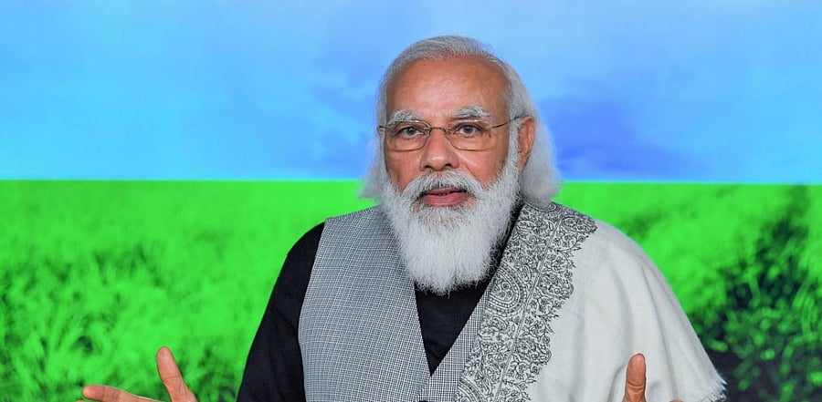 Prime Minister Narendra Modi releases the next installment of financial benefit under PM Kisan Samman Nidhi, through video conference. Credit: PTI/PIB.