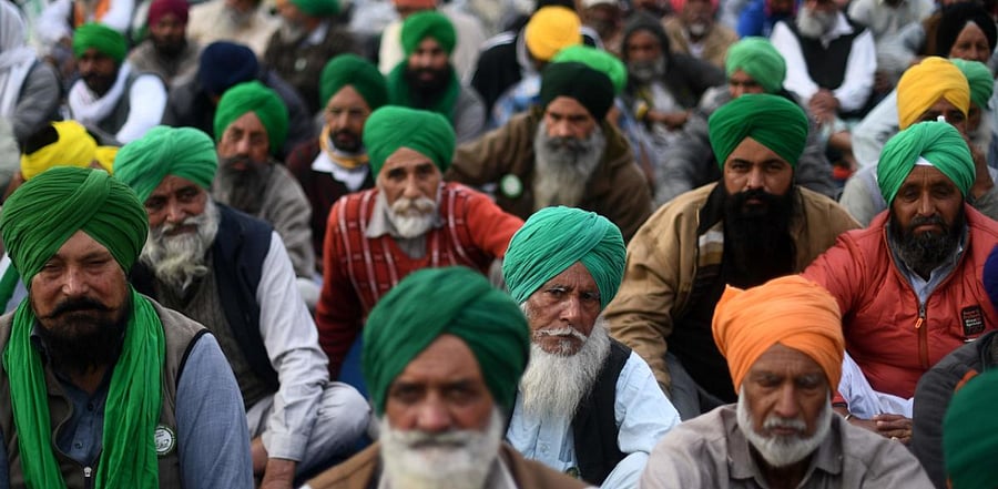Farmers take part in a protest against the central government's recent agricultural reforms as they block a highway at Tikri border in New Delhi. Credit: AFP Photo