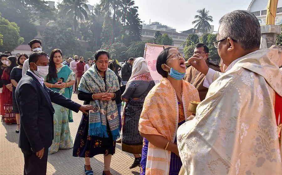Christian devotees receive communions on the occasion of Christmas, outside the Don Bosco Church, in Guwahati. Credit: PTI Photo