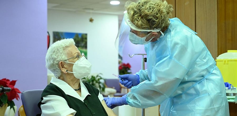 Araceli Hidalgo, 96, a resident of Los Olmos nursing home for the elderly, receives a dose of the Pfizer-BioNTech Covid-19 vaccine on December 27, 2020, in Guadalajara, becoming the first person vaccinated against coronavirus in Spain. Credit: AFP Photo