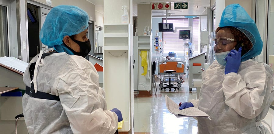 A medical staff speaks on a phone as she attends to a COVID-19 patient at a special ward at Arwyp Medical Centre in South Africa. Credit: Reuters.