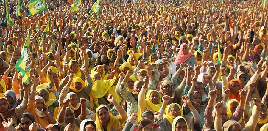 Women shout slogans as they take part farmers' ongoing agitation over new farm laws, at Tikri border in New Delhi. Credit: PTI.