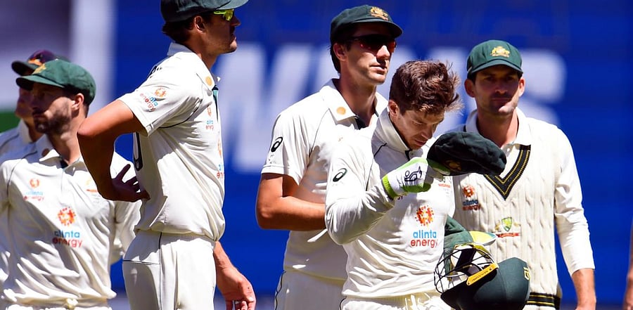  Australia's captain Tim Paine (2nd R) leads his team off the field after their loss to India in the second cricket Test match. Credit: AFP Photo