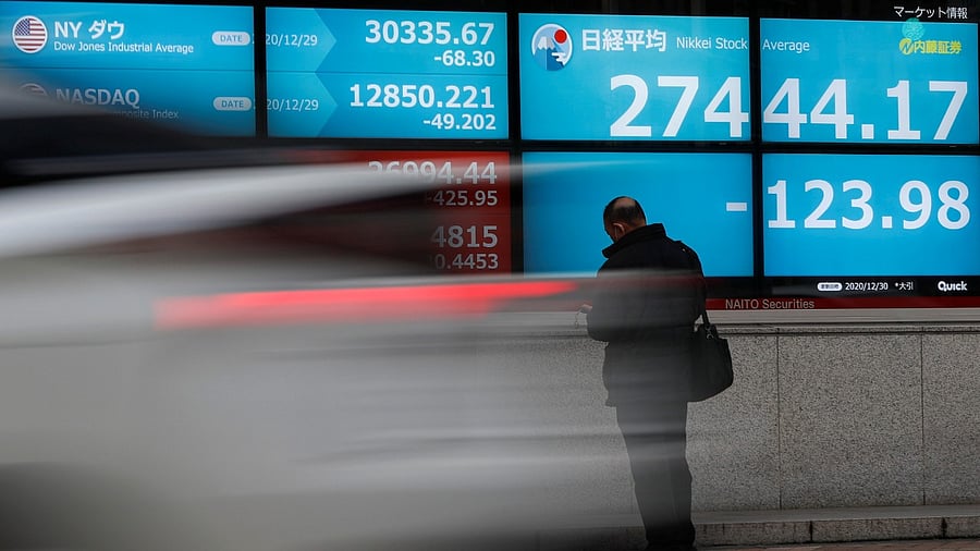 Screen displays Nikkei share average and stock indexes outside a brokerage in Tokyo. Credit: Reuters Photo