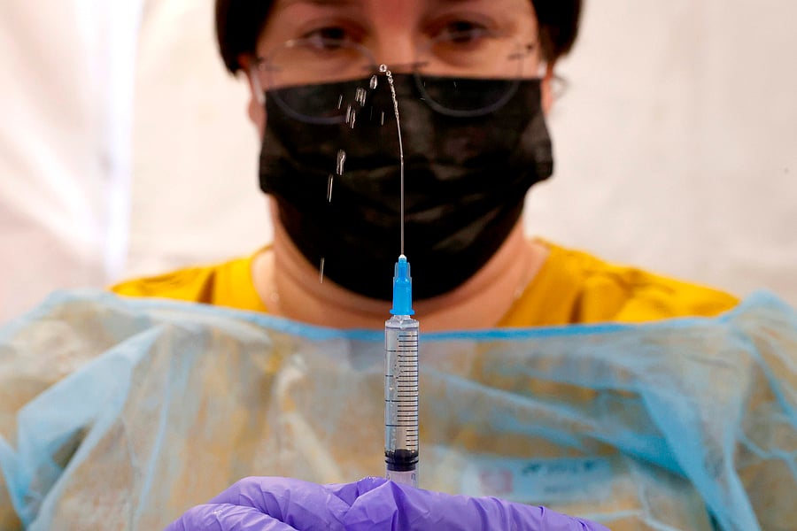 A healthcare worker prepares a dose of the Pfizer-BioNtech Covid-19 vaccine at a large vaccination centre. Credit: AFP Photo