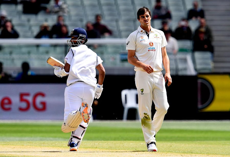 Australia's Pat Cummins reacts as Ajinkya Rahane runs between the wickets during the second Test at the MCG. Credit: AFP Photo