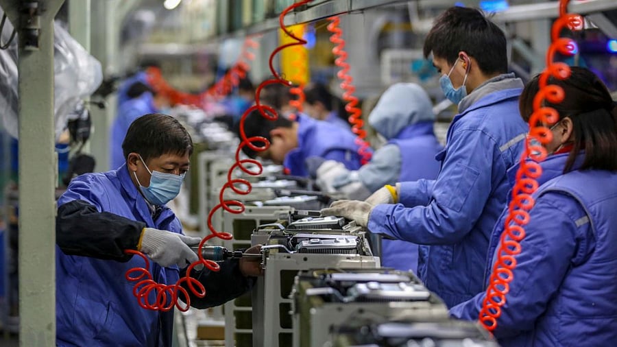 Employees work on an air conditioner production line at a Midea factory in Wuhan, in central China's Hubei province. Credit: AFP File Photo