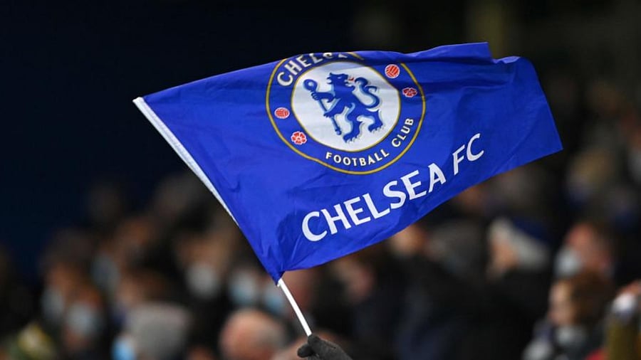 A fan waves a Chelsea FC flag. Credit: AFP File Photo