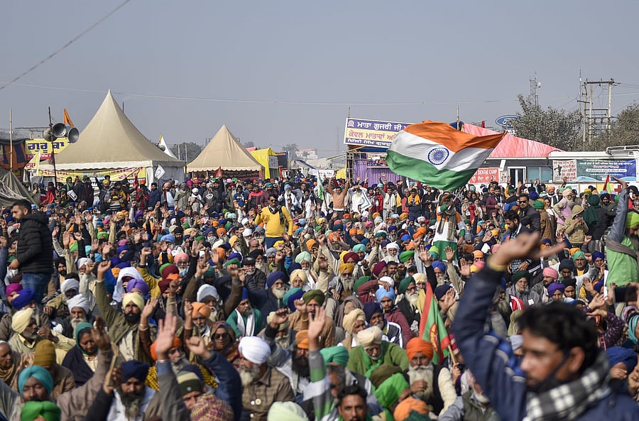 New Delhi: A farmer holds the Tricolor during a protest against the new farm laws, at Singhu Border in New Delhi, Wednesday, Dec. 30, 2020. (PTI Photo/Ravi Choudhary)(PTI30-12-2020_000116B)