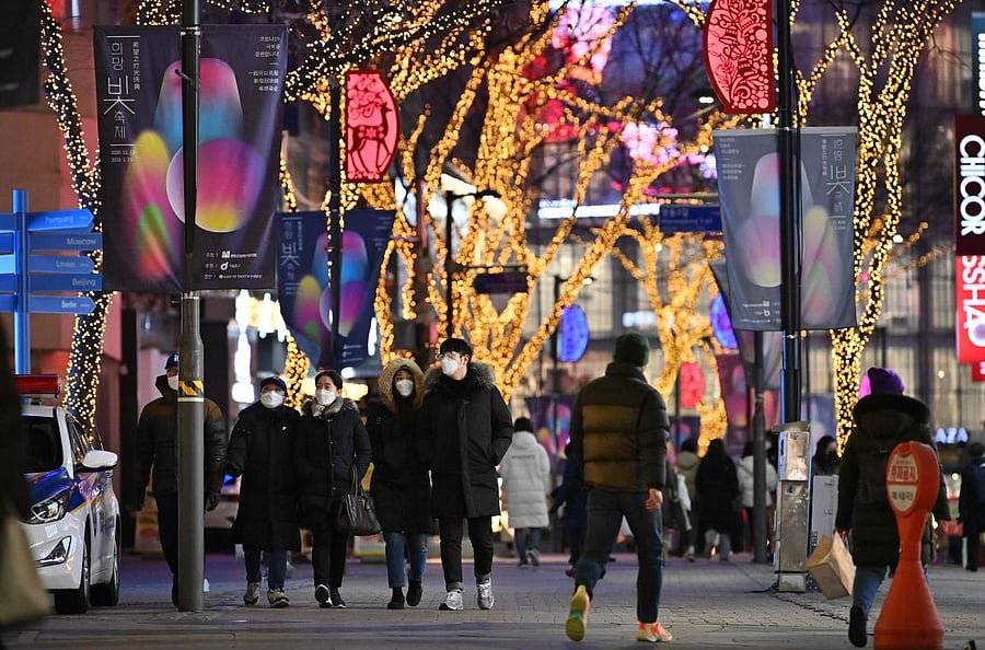 People visit a shopping district on New Year's Eve in Seoul. Credit: AFP.