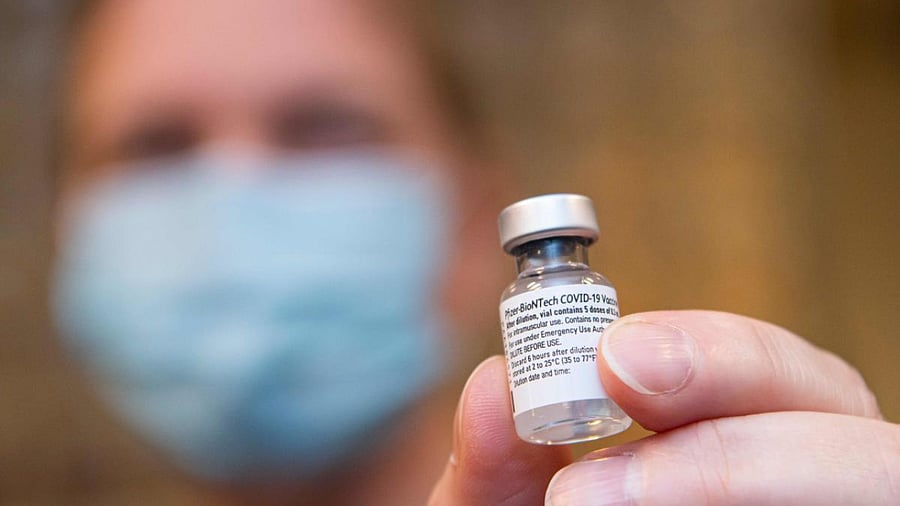 A nurse holds a vial of the Pfizer-BioNTech Covid-19, coronavirus vaccine. Credit: AFP