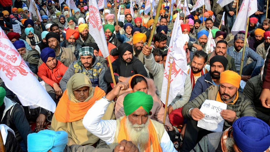 Farmers raise slogans during a protest against the new farm laws. Credit: PTI.