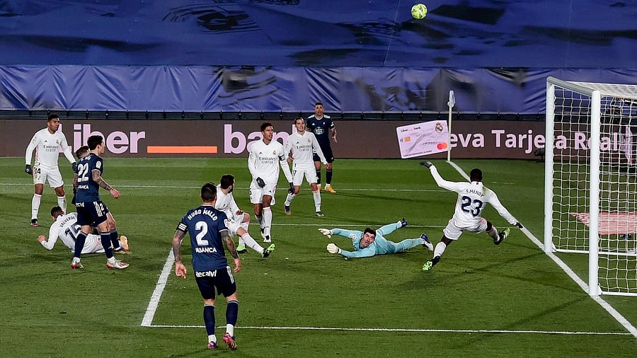 Real Madrid's French defender Ferland Mendy (R) and Real Madrid's Belgian goalkeeper Thibaut Courtois (2ndR) block a shot on goal during the Spanish League football match between Real Madrid and Celta Vigo. Credit: AFP Photo