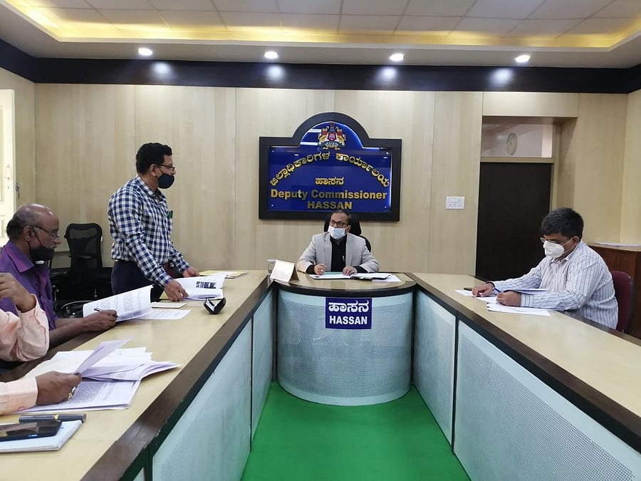 Deputy Commissioner R Girish holds a meeting with the officials in Hassan. Credit: DH.