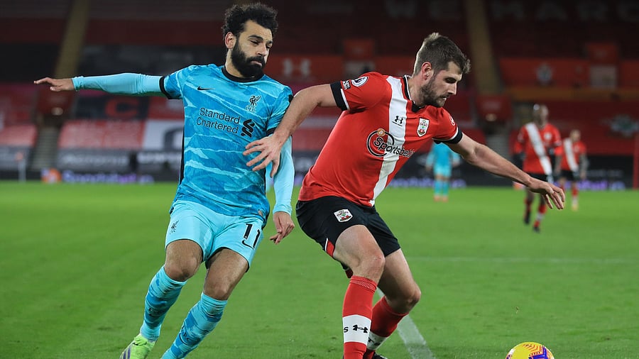 Southampton's English defender Jack Stephens (R) vies with Liverpool's Egyptian midfielder Mohamed Salah (L) during the English Premier League. Credit: AFP Photo