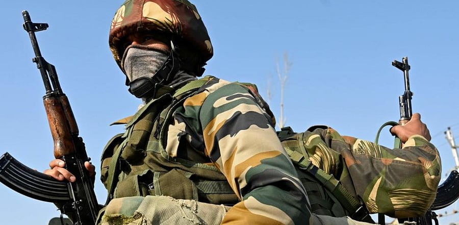Indian army soldiers stand guard during a gunbattle between suspected militants and government security forces at Lawaypora area on the outskirts of Srinagar on December 30, 2020. Credit: AFP Photo