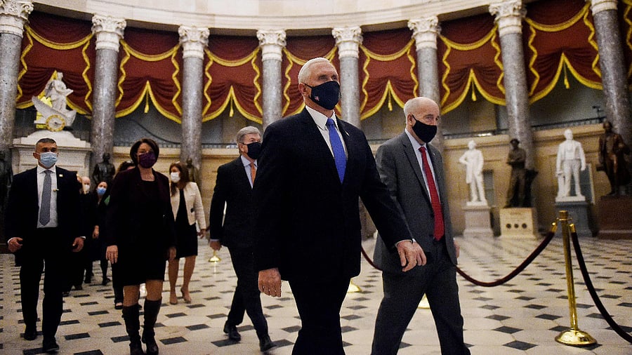US Vice President Mike Pence (C) walks back from the House Chamber followed by a Senate procession carrying boxes of Electoral Votes, at the Capitol. Credit: AFP Photo