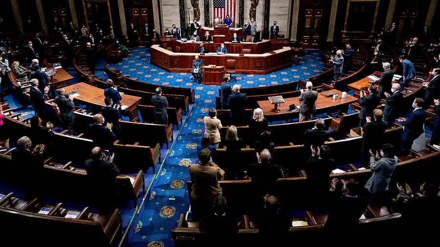 Republican and Democrats clap while House Minority Leader Kevin McCarthy (R-CA) commends Capitol Police and law enforcement for their work after rioters supporting President Donald Trump breached the US Capitol, as the House of Representatives. Credit: Reuters Photo