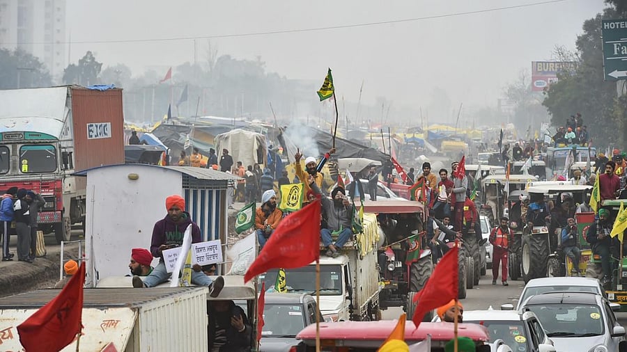 Farmers on their way to Tikri border during a tractor rally as part of their ongoing protest against the new farm laws, at Eastern Peripheral Expressway in New Delhi. Credit: PTI Photo