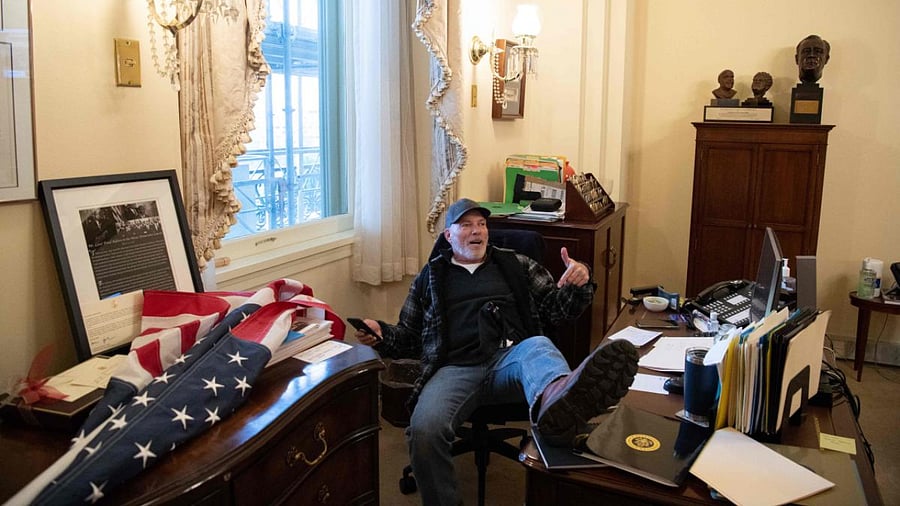 A supporter of US President Donald Trump sits inside the office of US Speaker of the House Nancy Pelosi as he protest inside the US Capitol in Washington, DC. AFP File Photo