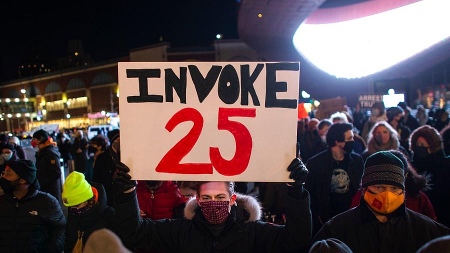 A demonstrator holds a sign calling for the 25th Amendment to remove US President Donald Trump from office during a protest outside the Barclays Center in Brooklyn, New York a day after pro-Trump mob stormed and trashed the Capitol. Credit: AFP Photo
