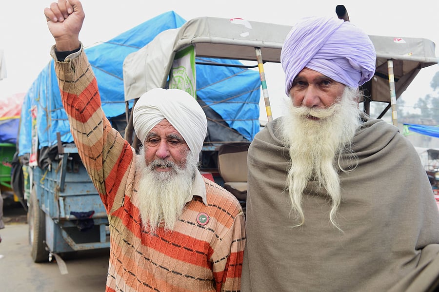  Farmers during their ongoing agitation against the new farm laws, at Singhu border, in New Delhi, Friday, Jan. 8, 2021. Credit: PTI Photo