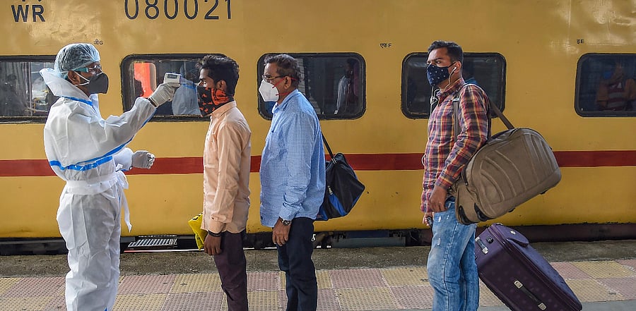 Passengers undergo thermal screening, amid coronavirus pandemic, at Bandra Terminus Railway Station in Mumbai. Credit: PTI Photo