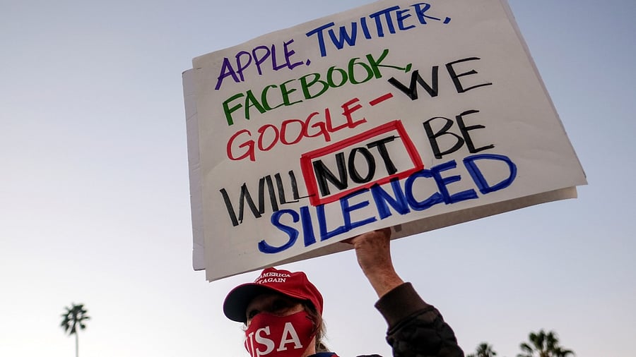 A supporter of US President Donald Trump holding a sign takes part in a rally at Beverly Hills Gardens Park in Beverly Hills, California, US on January 9, 2021. Credit: Reuters Photo/Ringo Chiu