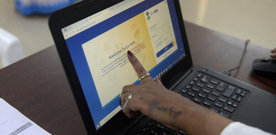 A health official shows a Co-WIN app to test beneficiaries as she takes part in dry run or a mock drill for Covid-19 coronavirus vaccine delivery at a primary health centre in Hyderabad. Credit: AFP Photo