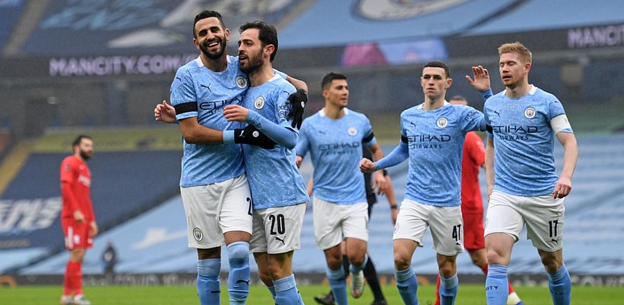 Manchester City's Portuguese midfielder Bernardo Silva (C) celebrates with teammates after scoring the opening goal of the English FA Cup third round football match between Manchester City and Birmingham City at the Etihad Stadium in Manchester, north west England. Credit: AFP Photo