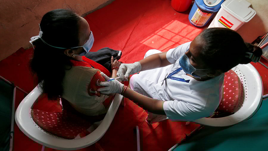 Healthcare workers take part in a nationwide trial run of Covid-19 vaccine delivery systems, inside a school which has been converted into a temporary vaccination centre. Credit: Reuters Photo