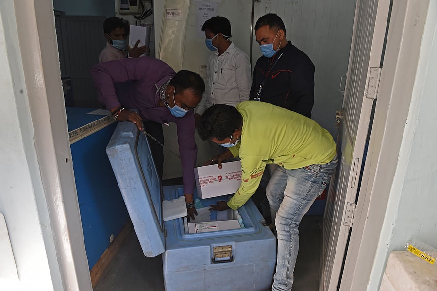 Officials put boxes of Covishield vaccine in a coldbox to maintain its temperature while transporting it to other regions from the regional vaccine store in Ahmedabad on January 12, 2021. Credit: AFP Photo