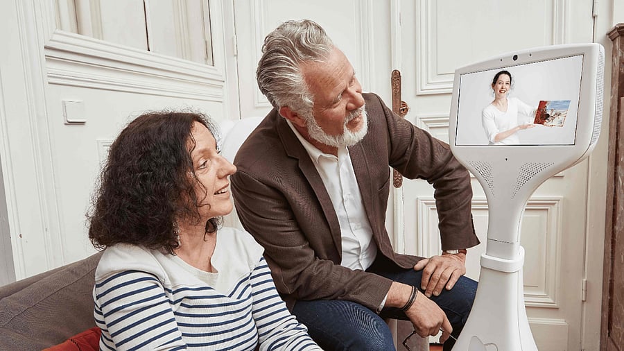 Françoise and Olivier, at their home in France, enjoy a live activity hosted from the Beaux Arts Museum in France on the Cutii robot. Credit: AFP Photo/ Courtesy of Carecelever SAS/Handout