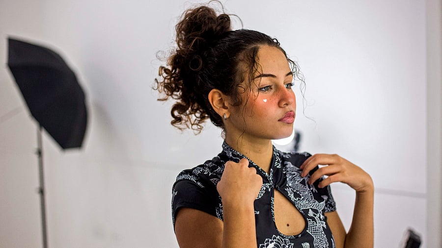 Valery Lopez prepares for a photoshoot to make content for her OnlyFans profile, in Caracas. Credit: AFP Photo