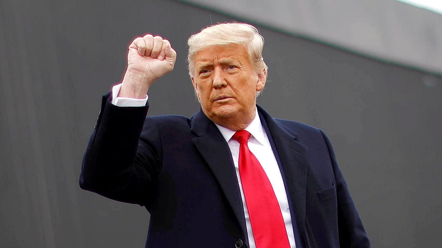 US President Donald Trump raises his fist as he visits the US-Mexico border wall, in Alamo, Texas. Credit: Reuters Photo