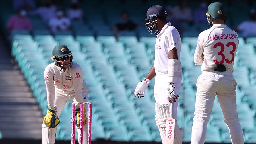 Ashwin speaks with Australia's captain Tim Paine. Credit: AFP Photo